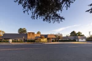 Arden Park building, entrance, and landscaping viewed from across the street.