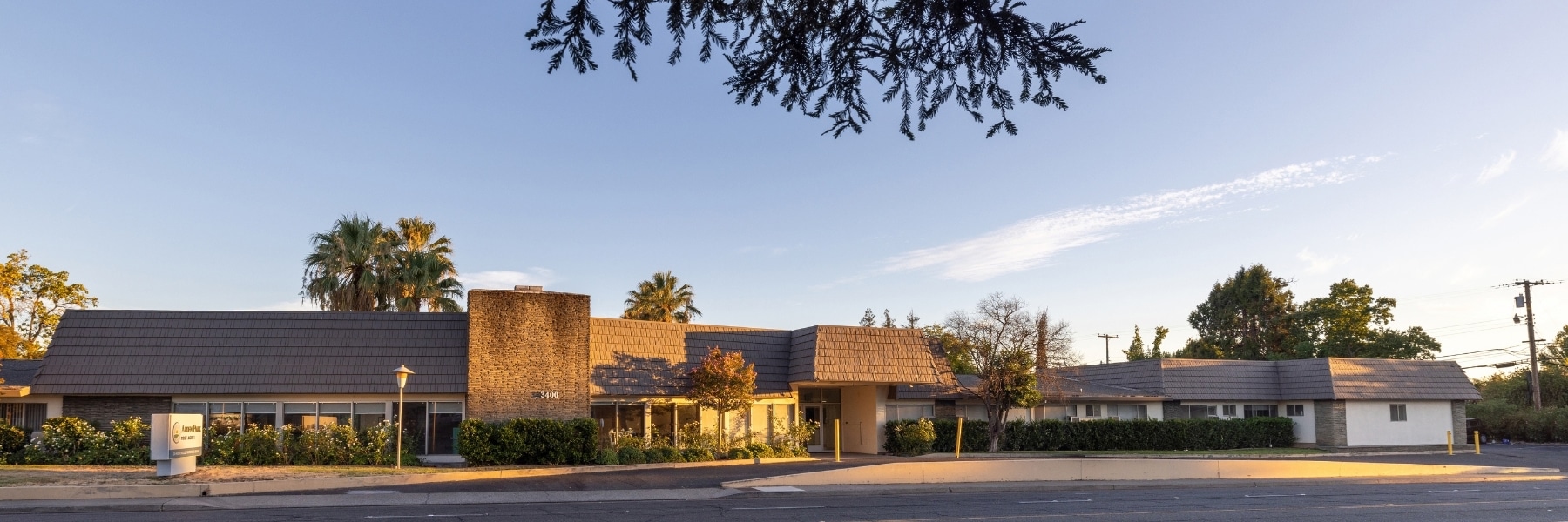 Wide view of the Arden Park building, entrance, and landscaping.